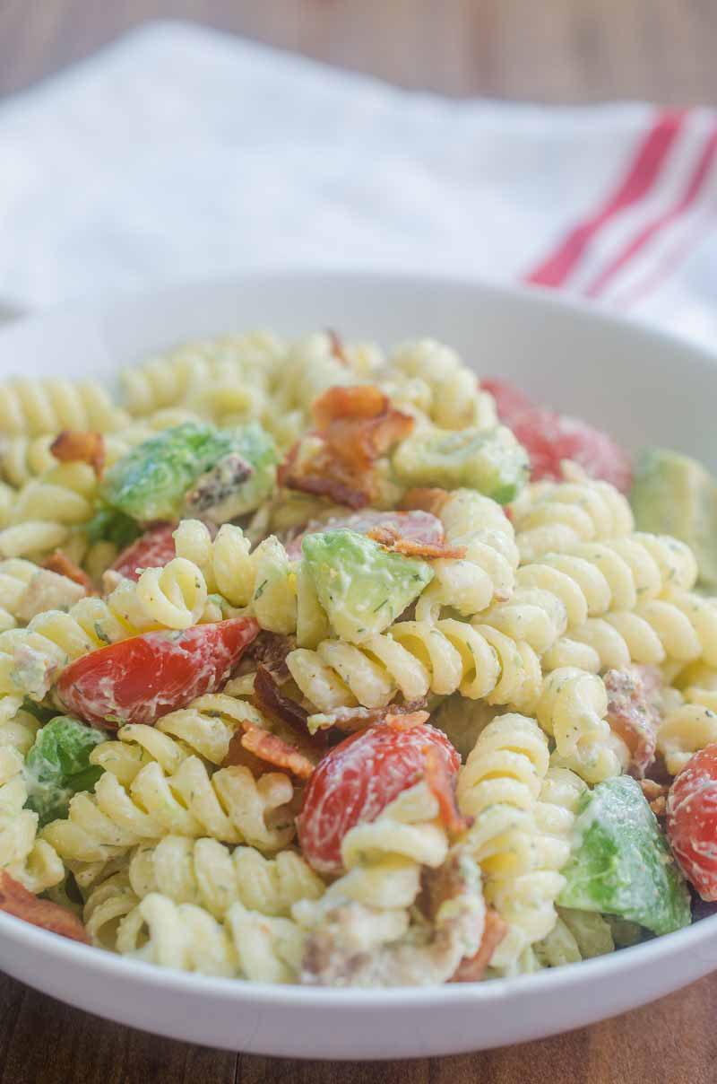 Make all the friends this summer with this Bacon Tomato Avocado Pasta Salad. It's a family favorite with crispy bacon, creamy avocado and sweet summer tomatoes.