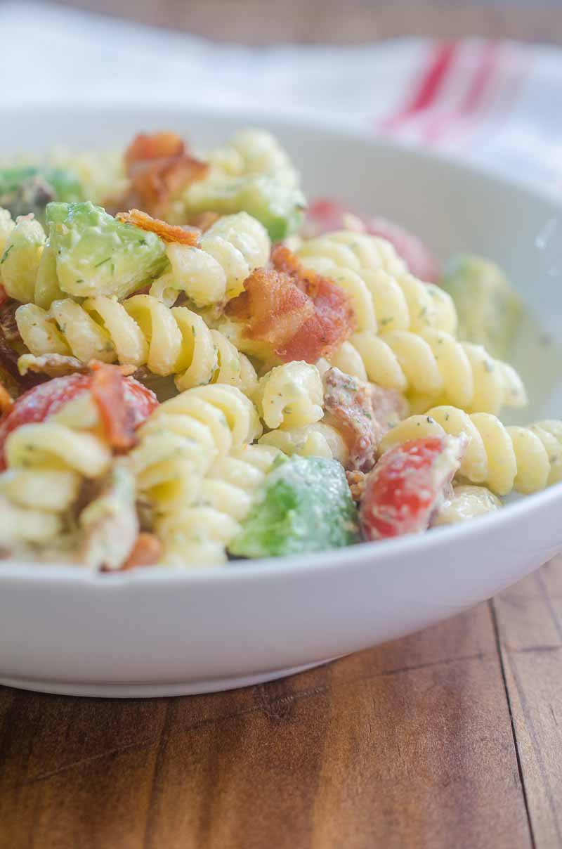 Make all the friends this summer with this Bacon Tomato Avocado Pasta Salad. It's a family favorite with crispy bacon, creamy avocado and sweet summer tomatoes.