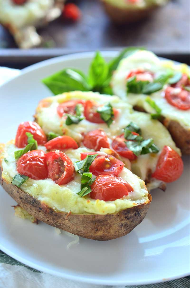 A comfort food classic gets a summer time twist with these Caprese Twice Baked Potatoes. They are loaded with pesto, mozzarella, tomatoes and fresh basil.
