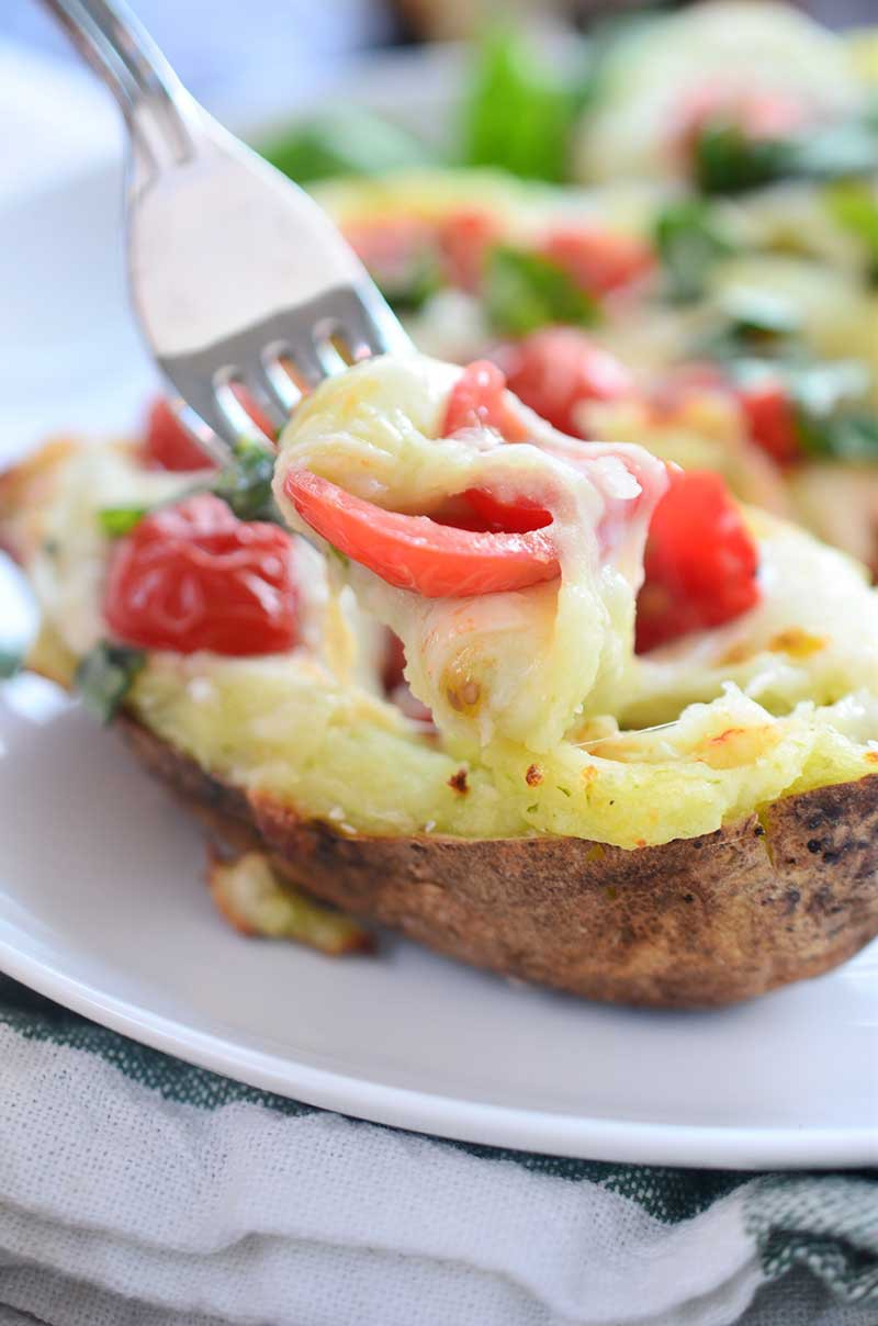 A comfort food classic gets a summer time twist with these Caprese Twice Baked Potatoes. They are loaded with pesto, mozzarella, tomatoes and fresh basil.