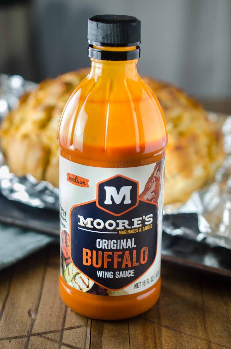 #ad This Cheesy Buffalo Pull-Apart Bread loaded with 3 cheeses, chicken and Moore's Original Buffalo Sauce, is perfect for all of your game day shenanigans! 