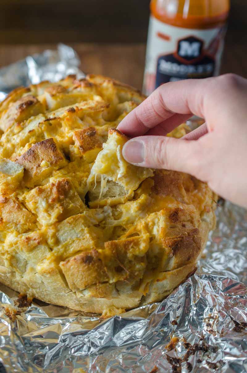 #ad This Cheesy Buffalo Pull-Apart Bread loaded with 3 cheeses, chicken and Moore's Original Buffalo Sauce, is perfect for all of your game day shenanigans! 