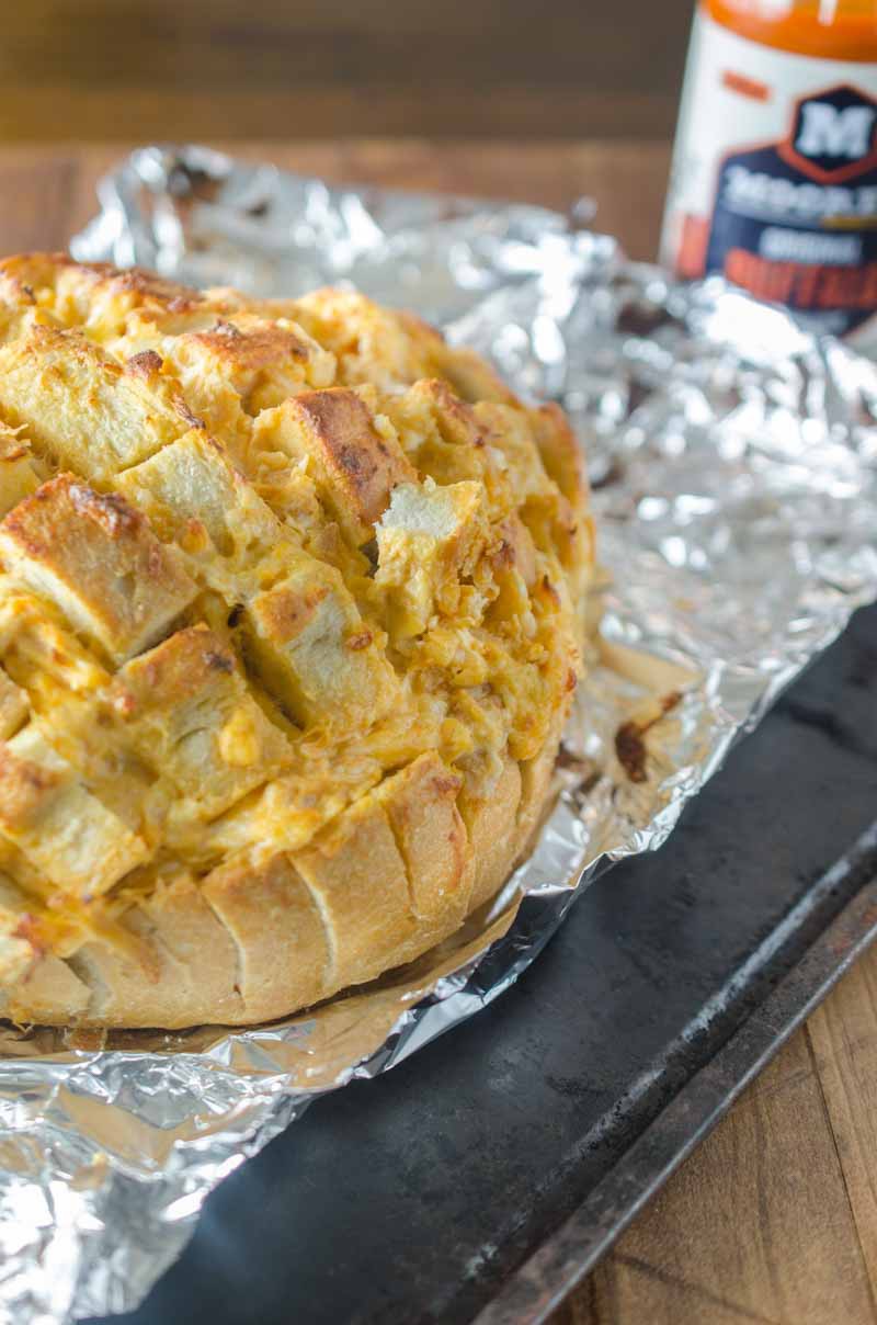 #ad This Cheesy Buffalo Pull-Apart Bread loaded with 3 cheeses, chicken and Moore's Original Buffalo Sauce, is perfect for all of your game day shenanigans! 