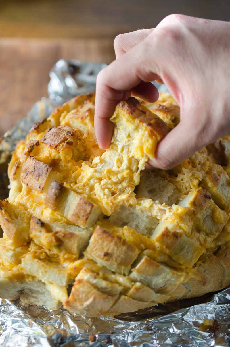 #ad This Cheesy Buffalo Pull-Apart Bread loaded with 3 cheeses, chicken and Moore's Original Buffalo Sauce, is perfect for all of your game day shenanigans! 