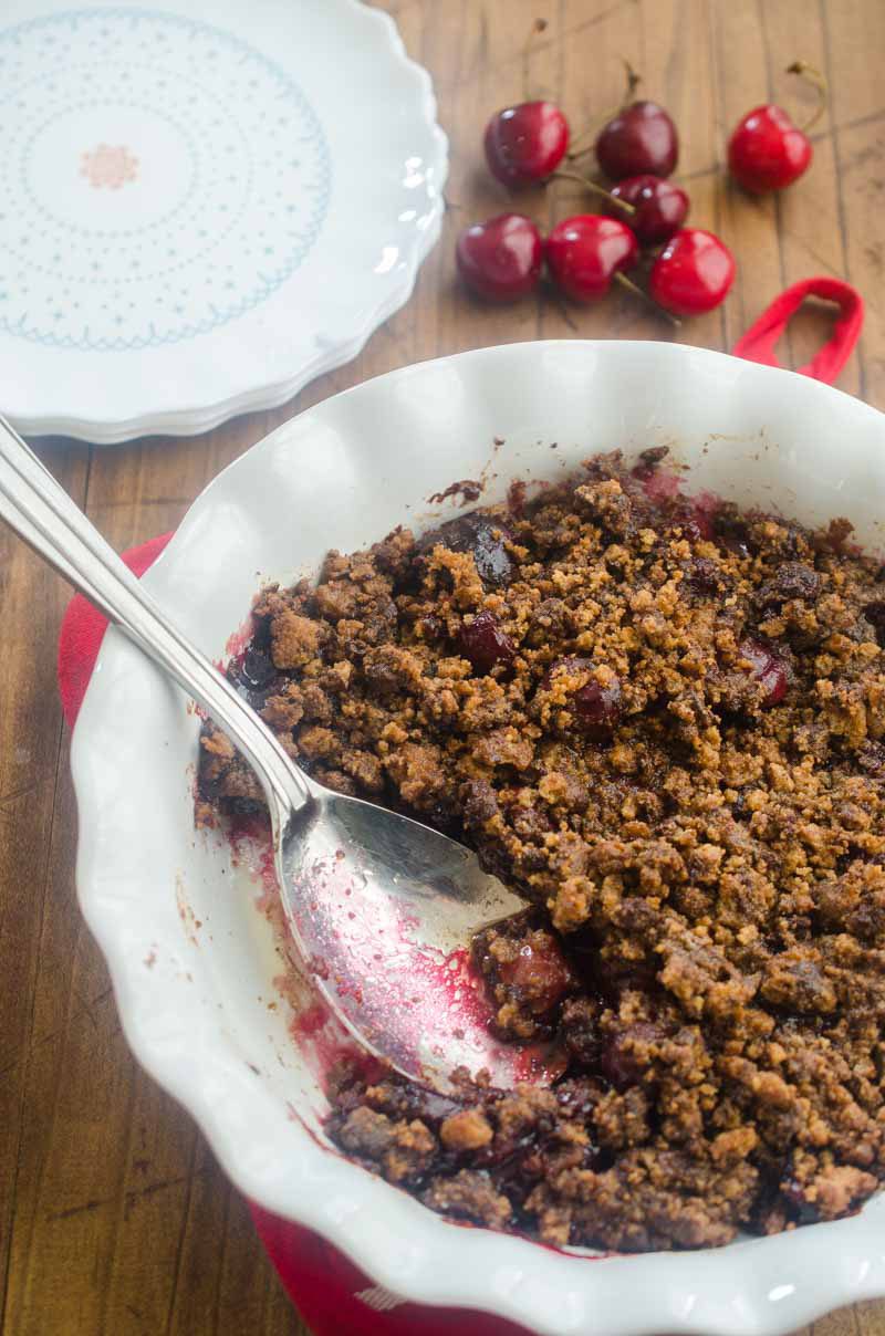 This Cherry Chocolate Chip Cookie Crisp is the perfect way to use summer cherries. Fresh sweet cherries topped with a chocolate chip cookie crumble and baked until bubbly.