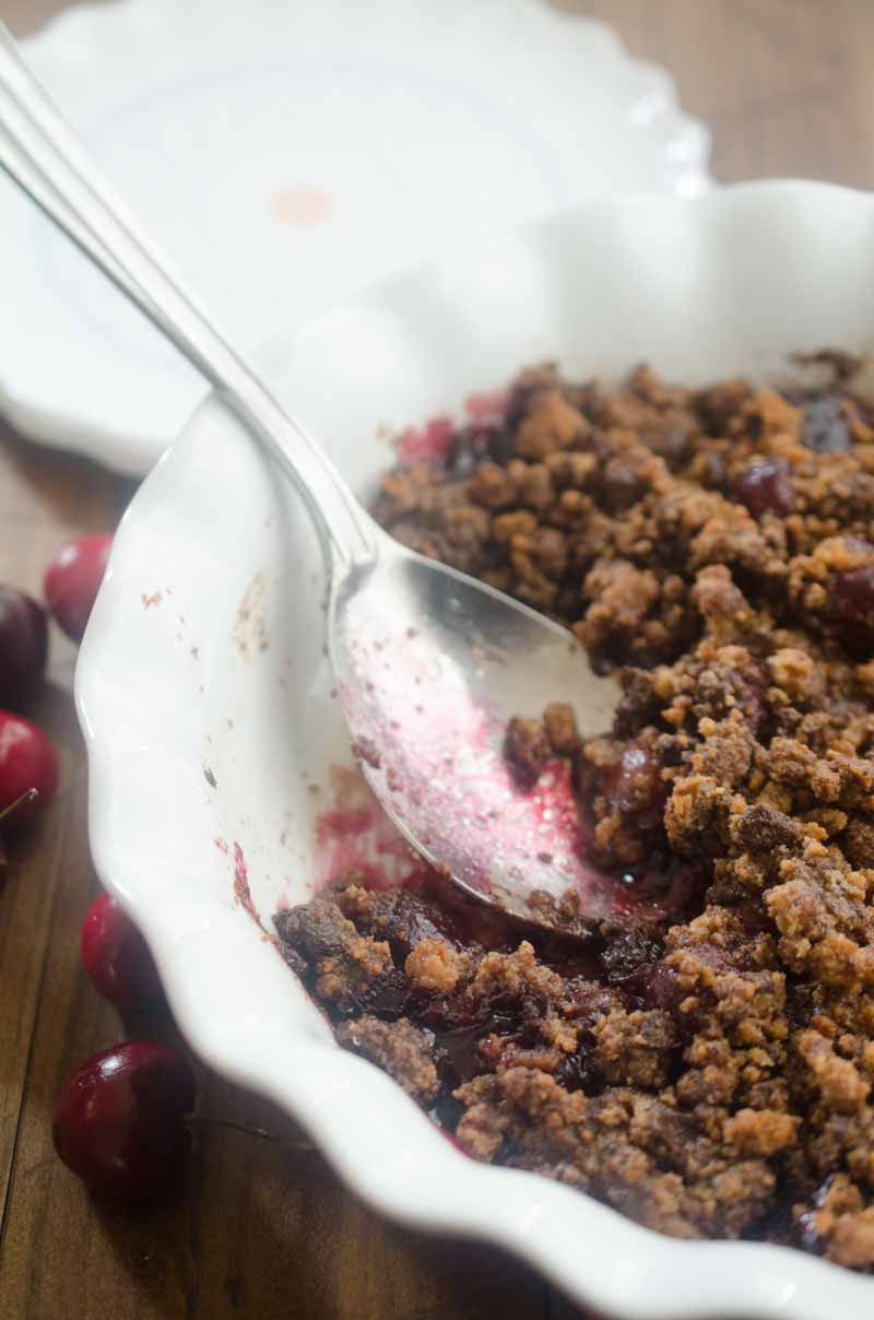 This Cherry Chocolate Chip Cookie Crisp is the perfect way to use summer cherries. Fresh sweet cherries topped with a chocolate chip cookie crumble and baked until bubbly.