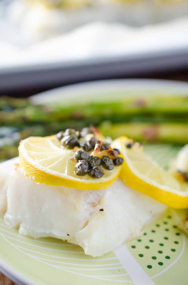 This Cod and Asparagus Sheet Pan Dinner topped with lemons and caper butter just screams easy spring meal!