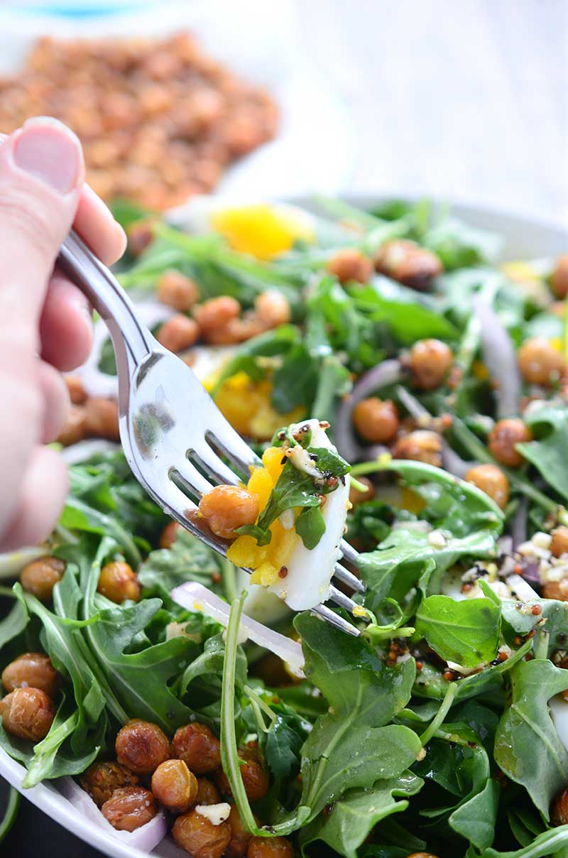 This crispy chickpea and arugula salad is loaded with arugula, crispy fried chickpeas, boiled eggs, shallots and then drizzled with a mustard vinaigrette.