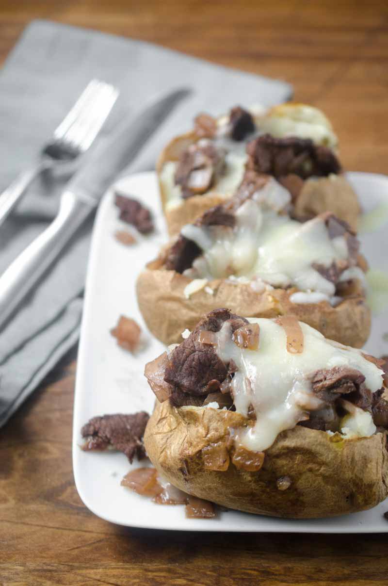 Make baked potatoes a meal with these French-Style Beef Baked Potatoes. They are loaded with thinly slice top sirloin, caramelized onion sauce and shredded Swiss cheese.