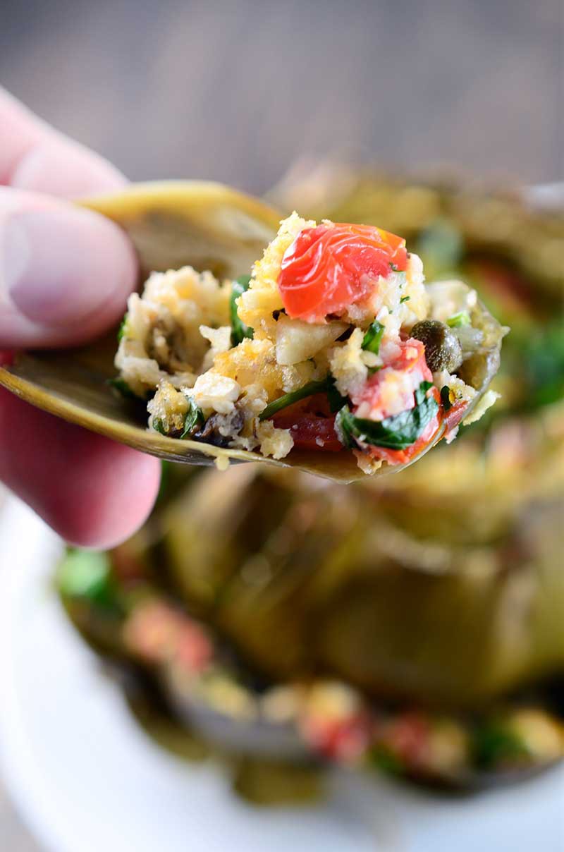 Artichokes loaded with kalamata olives, garlic, olive oil, parsley, oregano, bread crumbs, tomatoes, feta and capers make these Greek Stuffed Artichokes a gorgeous way to welcome spring!