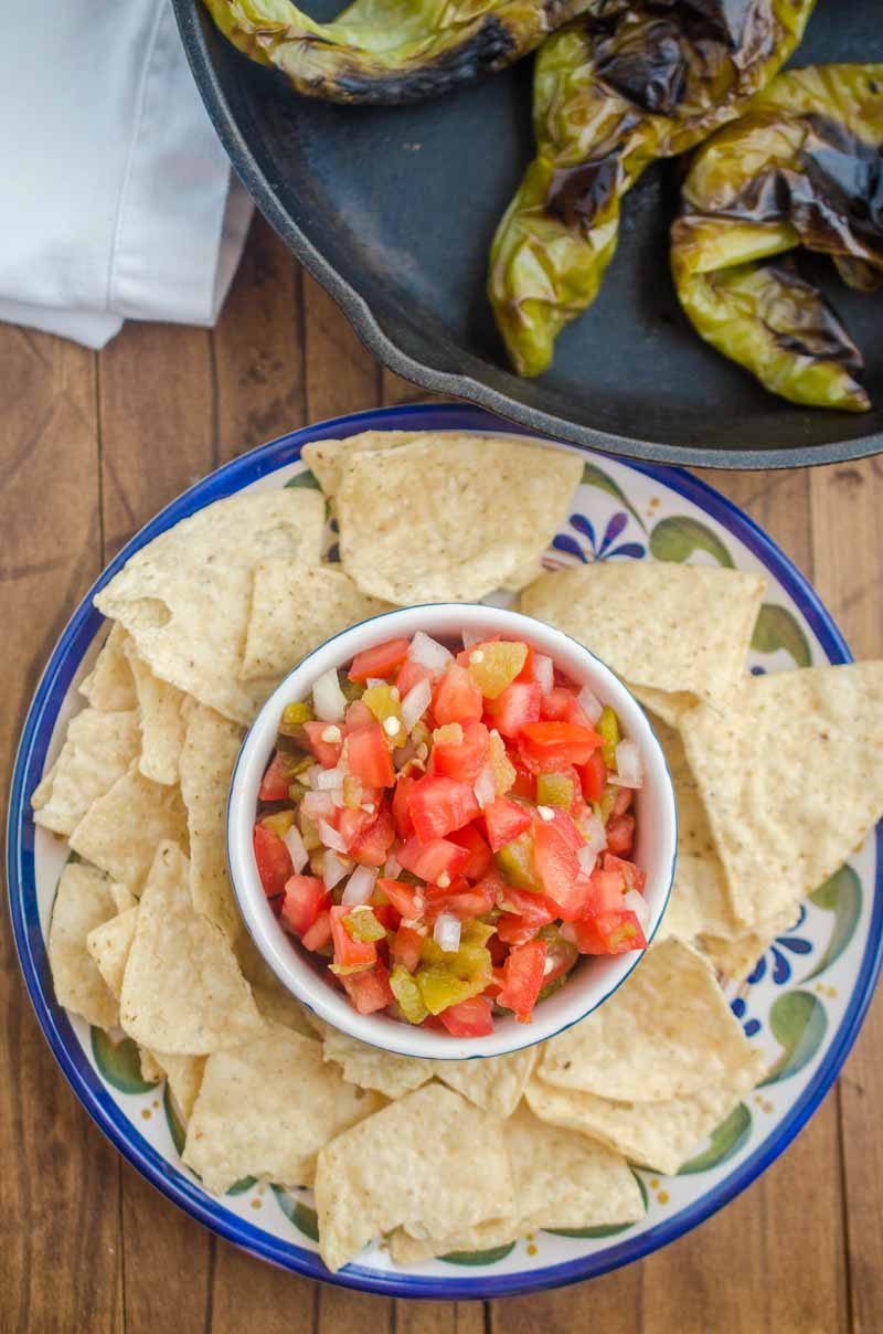 Hatch Chile Salsa Fresca is made with roasted hatch chilies, fresh tomatoes, onions, garlic and lime. It's a fun twist on fresh salsa!