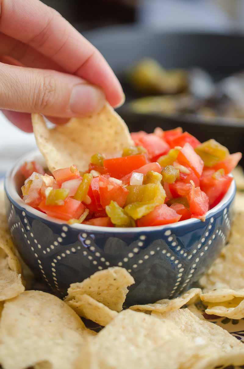 Hatch Chile Salsa Fresca is made with roasted hatch chilies, fresh tomatoes, onions, garlic and lime. It's a fun twist on fresh salsa!