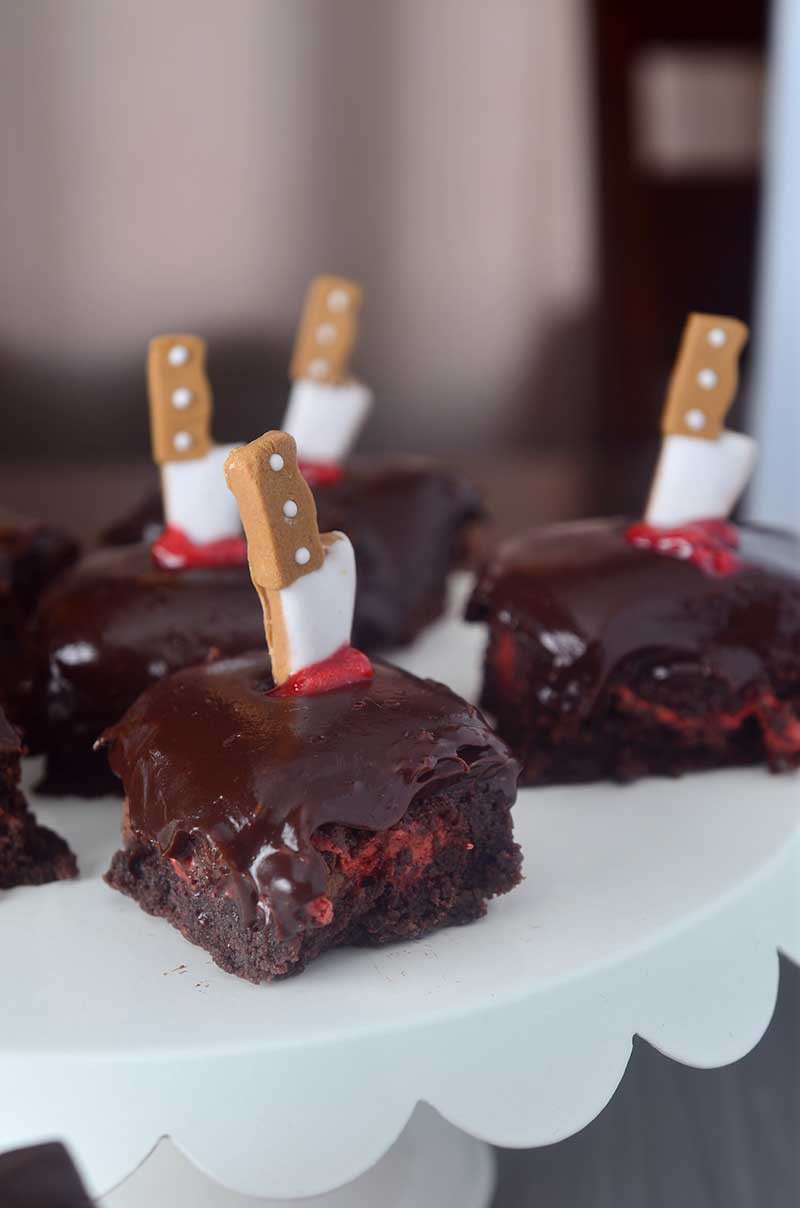 Killer Fudge Brownies are stuffed with Three Musketeers, topped with a layer of decadent chocolate ganache and a little Halloween flare. Perfect for parties