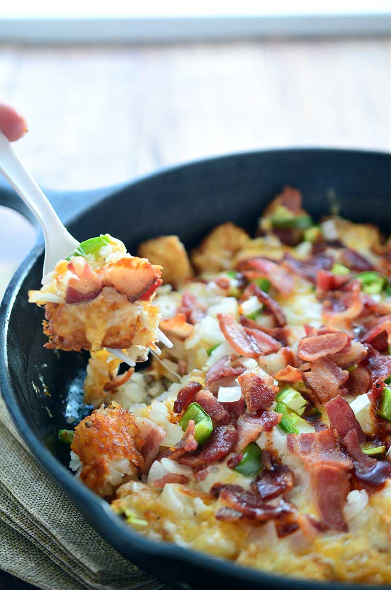 These loaded tailgate tots are perfect for game day! They are loaded with 2 cheeses, onions, jalapeños, bacon and then drizzled with BBQ sauce. 