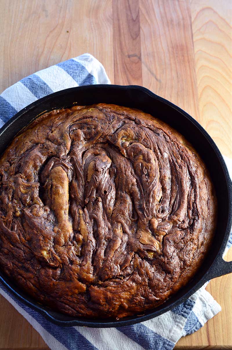 This skillet Nutella banana bread is moist, decadent and loaded with bananas and Nutella. It makes a great breakfast AND dessert.