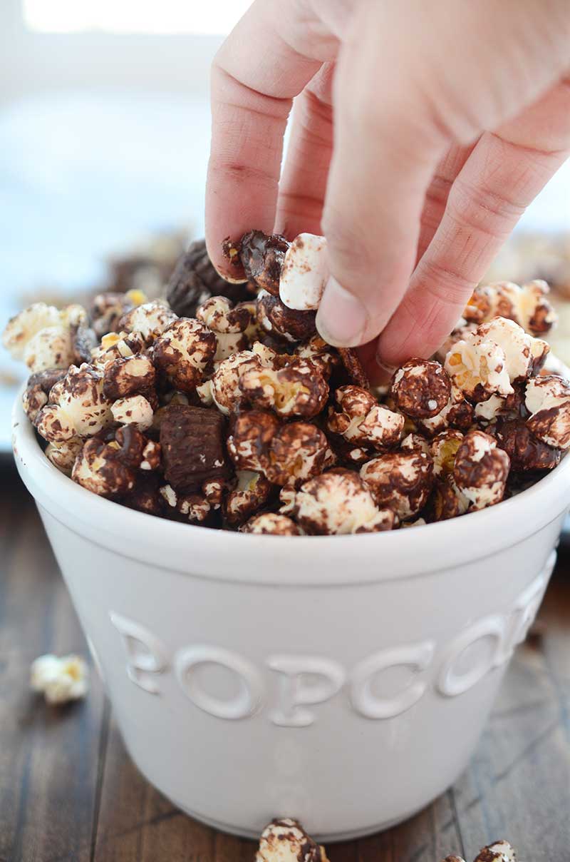 Peanut Butter Cup S'mores Popcorn one heck of a salty/sweet snack. It is loaded with popcorn, peanut butter cups, marshmallows, graham cereal and chocolate.