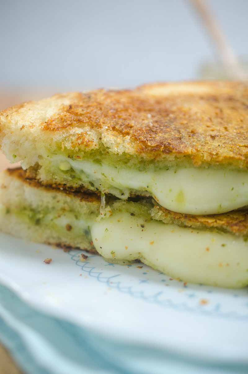 Pesto Grilled Cheese. Pesto and Mozzarella sandwiched between Parmesan crusted bread and then grilled to perfection.