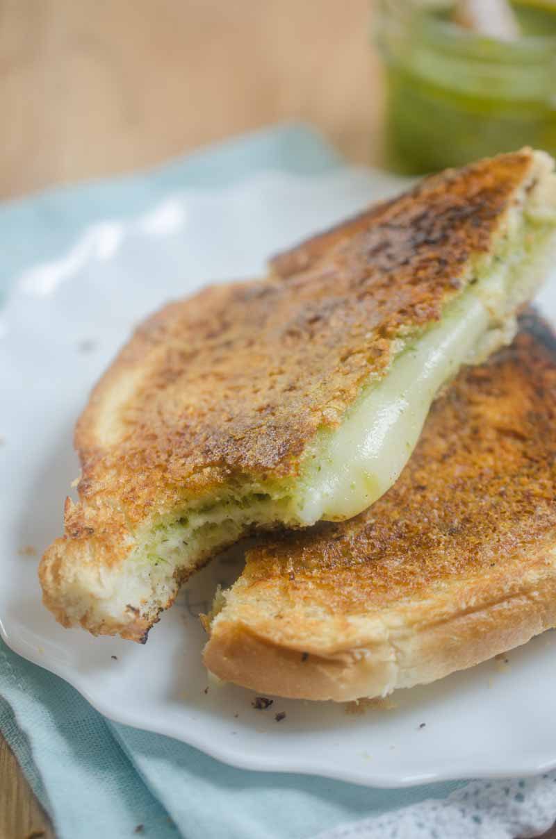 Pesto Grilled Cheese. Pesto and Mozzarella sandwiched between Parmesan crusted bread and then grilled to perfection.