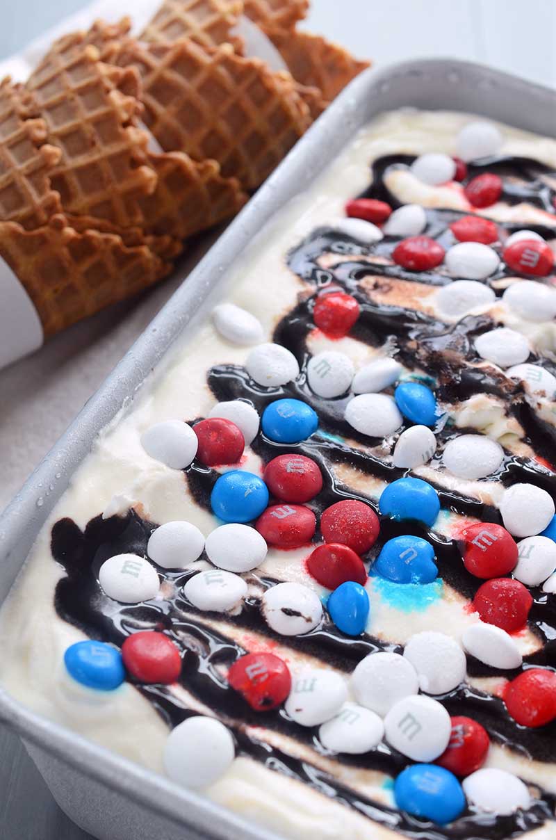 Loaded with M&Ms, fudge and caramel ,this no-churn, Red, White, and Blue M&M ice cream is perfect for your 4th of July celebrations!