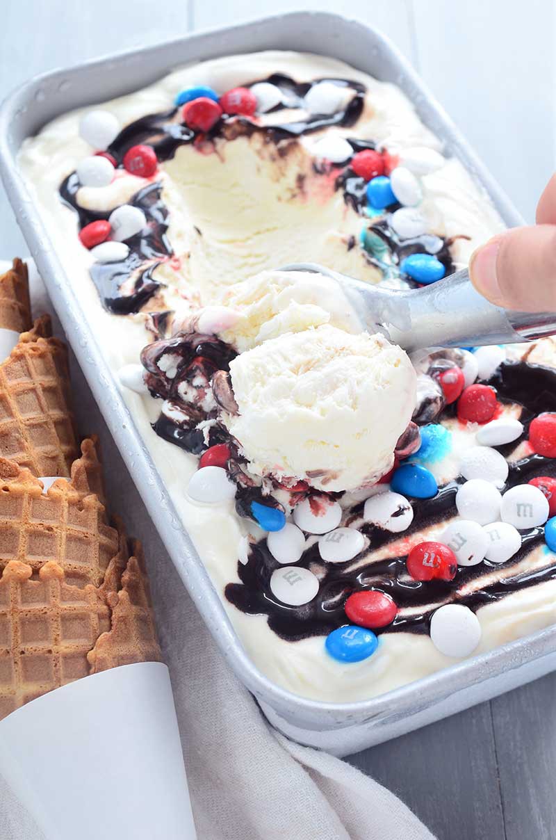 Loaded with M&Ms, fudge and caramel ,this no-churn, Red, White, and Blue M&M ice cream is perfect for your 4th of July celebrations!