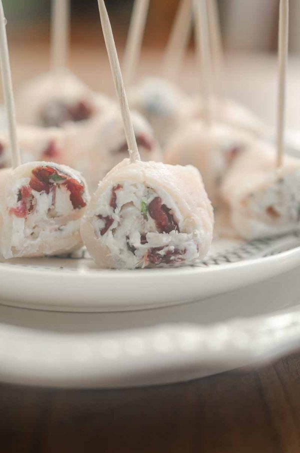 Cranberry Turkey Rollups are a perfect holiday appetizer loaded with turkey, cream cheese, cranberries and rosemary. Great for parties!