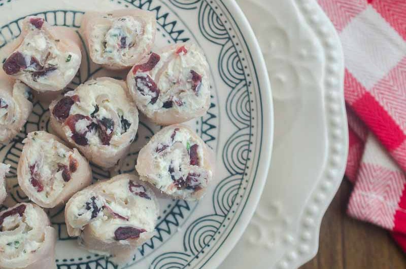 Cranberry Turkey Rollups are a perfect holiday appetizer loaded with turkey, cream cheese, cranberries and rosemary. Your guests will love them!