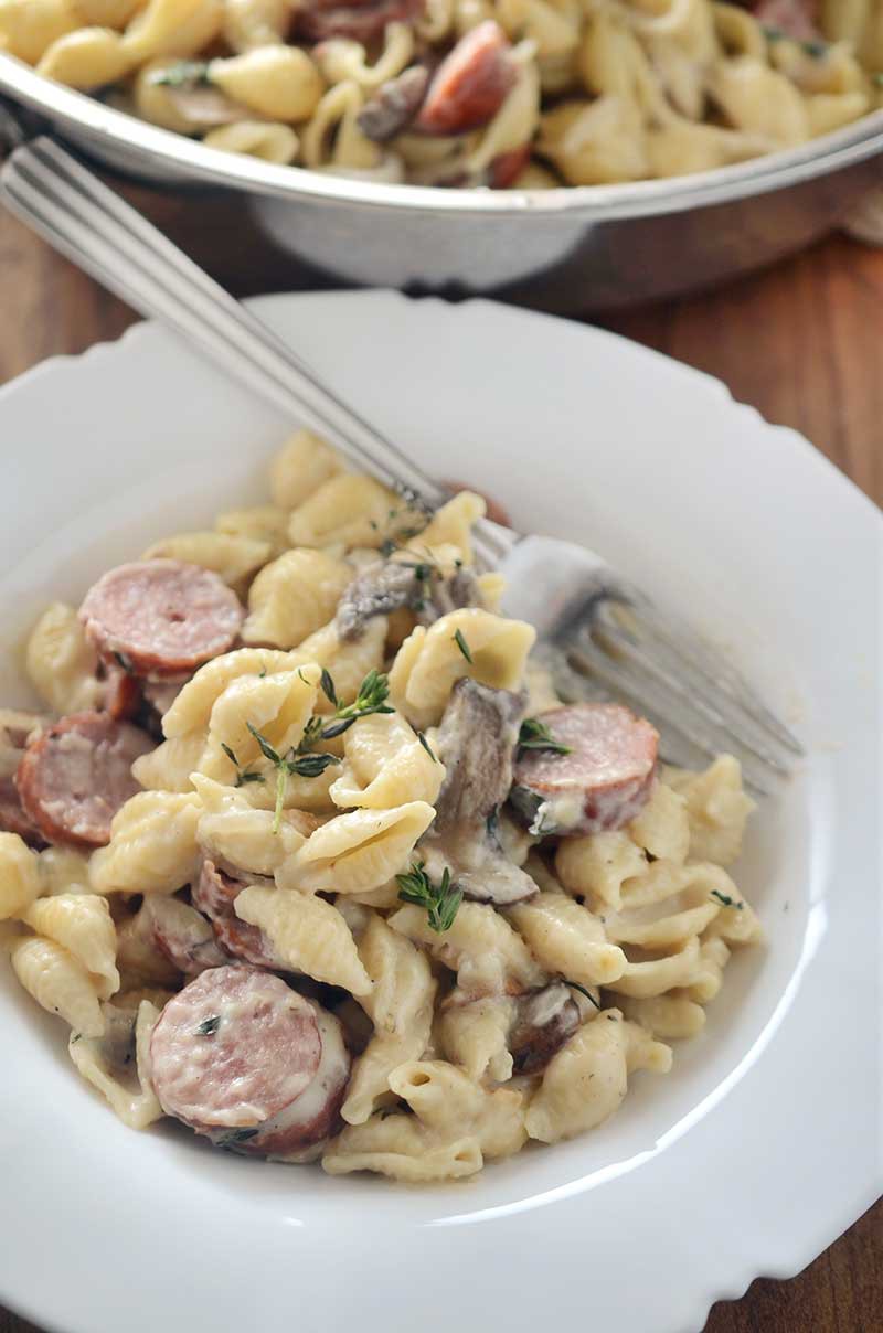 Dinner doesn't get more comforting than this Sausage and Mushroom Mac n' Cheese. This pasta is loaded with smoky sausage, mushrooms, swiss cheese and thyme. It's the perfect fall dinner! 