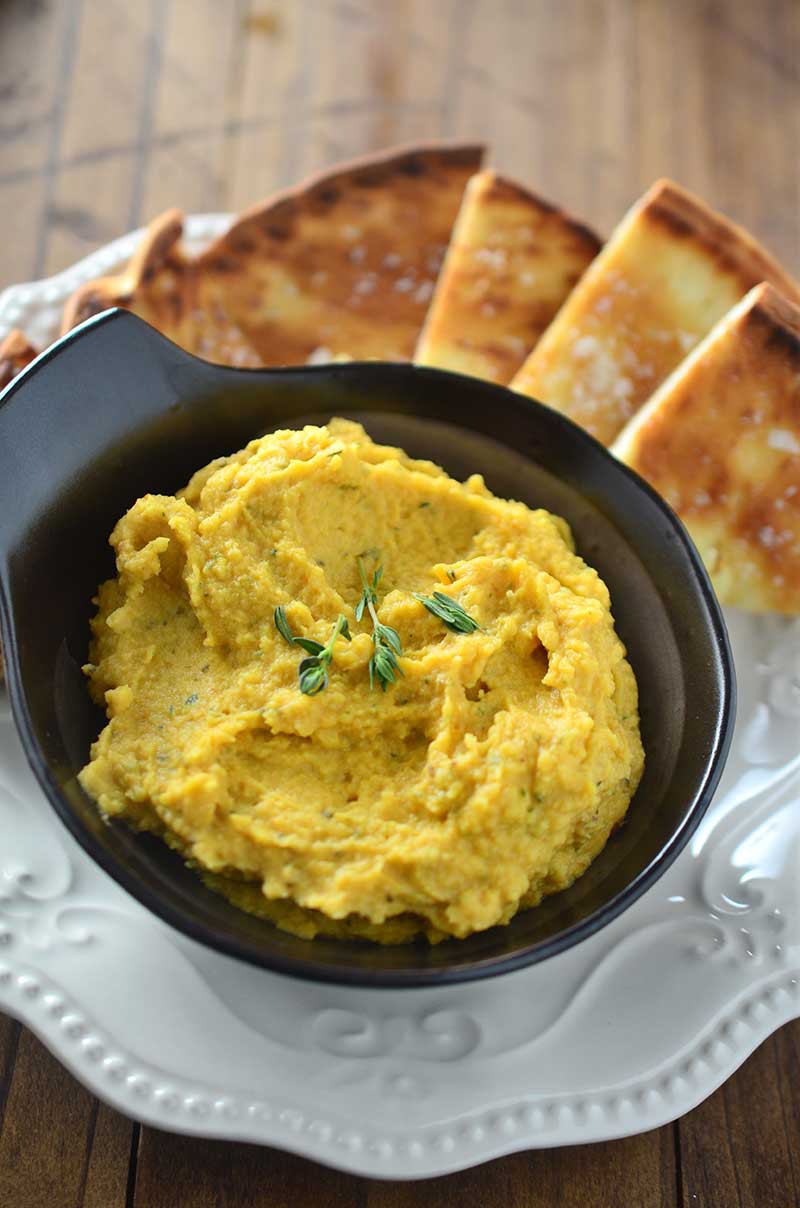 A savory pumpkin hummus with pumpkin, garlic, thyme and rosemary. The perfect dip for holiday get togethers!