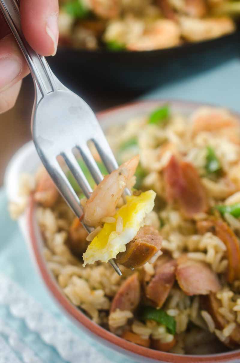 Andouille and Shrimp Fried Rice is loaded with all kinds of goodies! Spicy andouille, succulent shrimp, eggs, bacon and veggies.