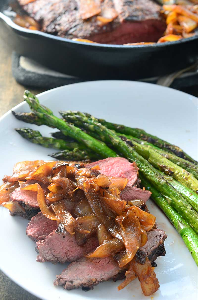 Perfectly grilled steak smothered with sriracha caramelized onions. The perfect excuse to break out your grill!