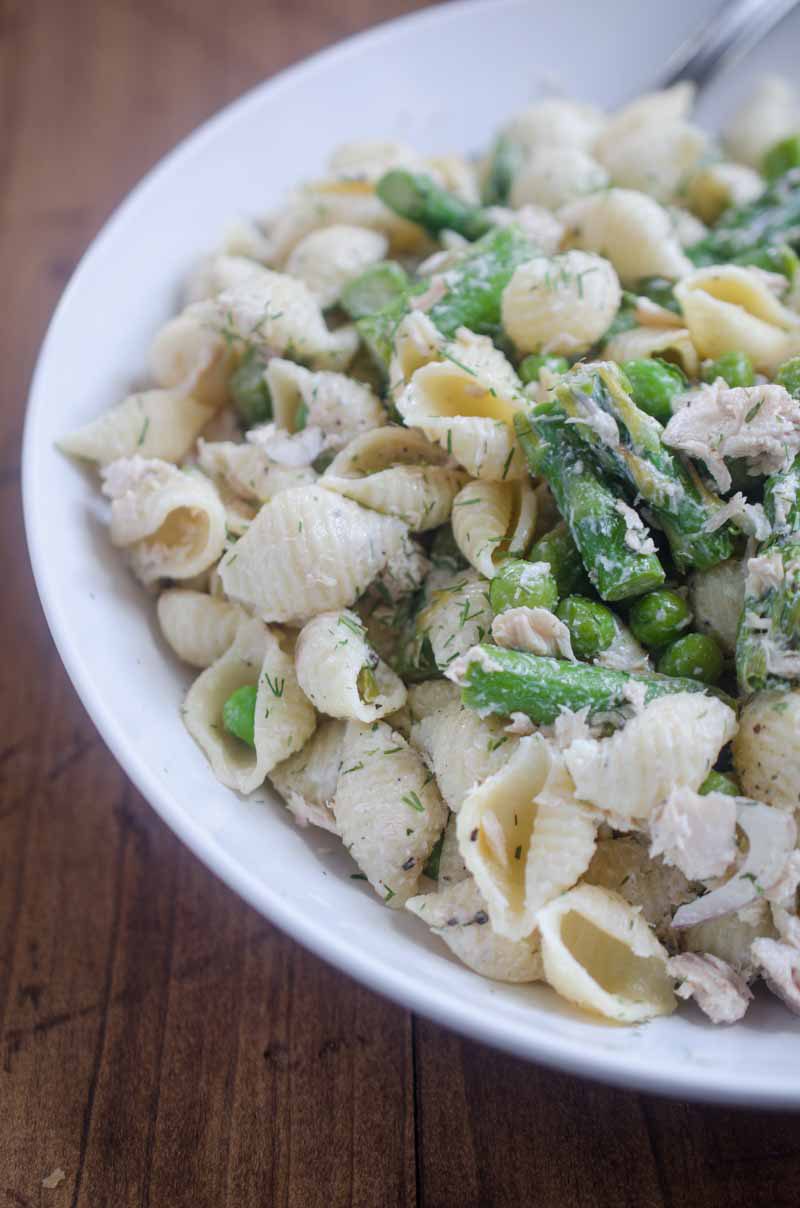 A spring take on Tuna Pasta Salad with peas and asparagus in a creamy dill dressing. 
