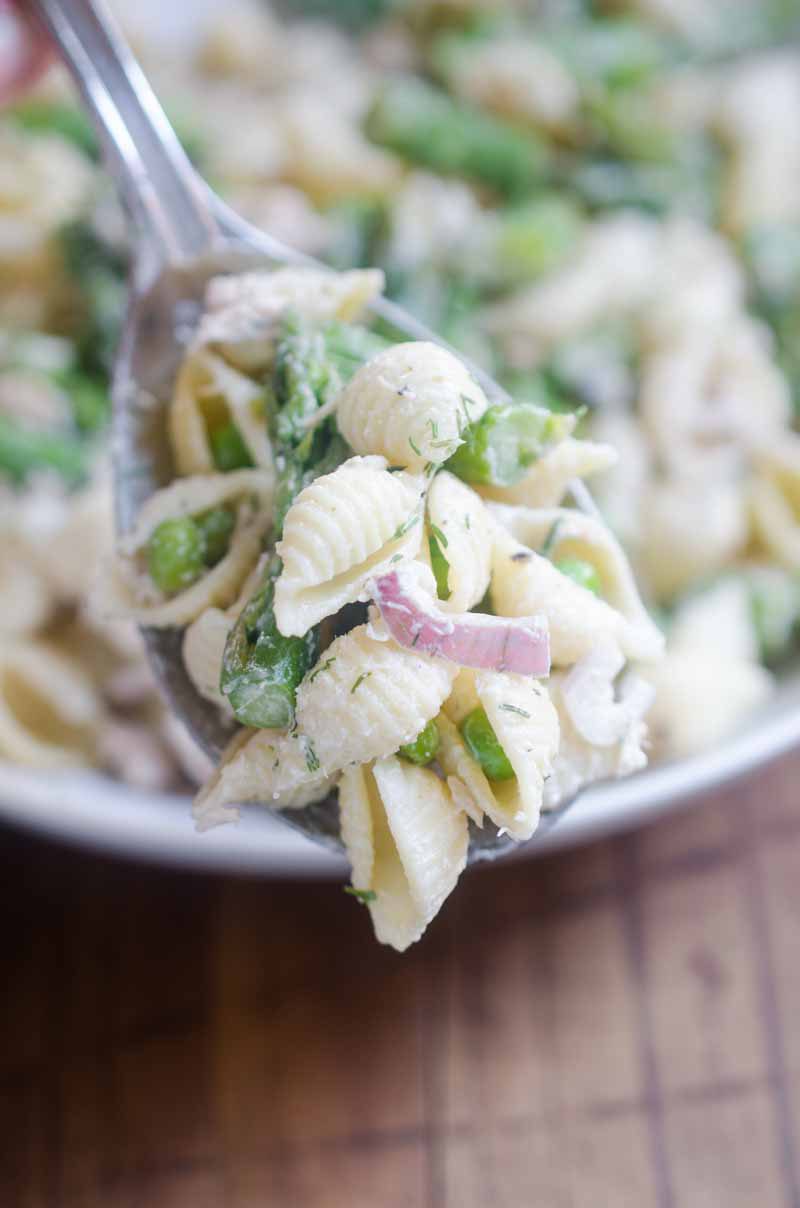 A spring take on Tuna Pasta Salad with peas and asparagus in a creamy dill dressing. 