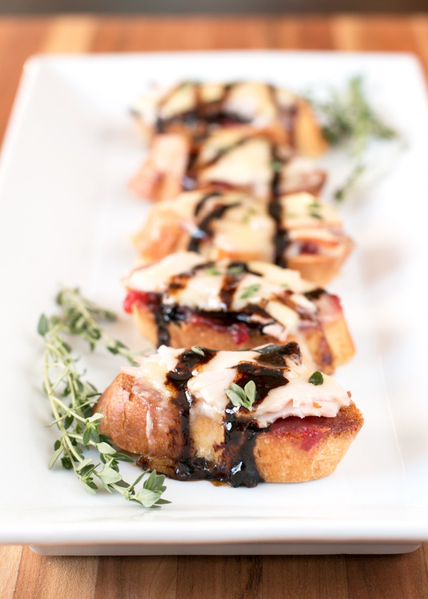 Turkey Brie Crostini. A combination of turkey and cranberry sauce to get you in the mood for Thanksgiving dinner, plus a hefty dose of melted, gooey brie.