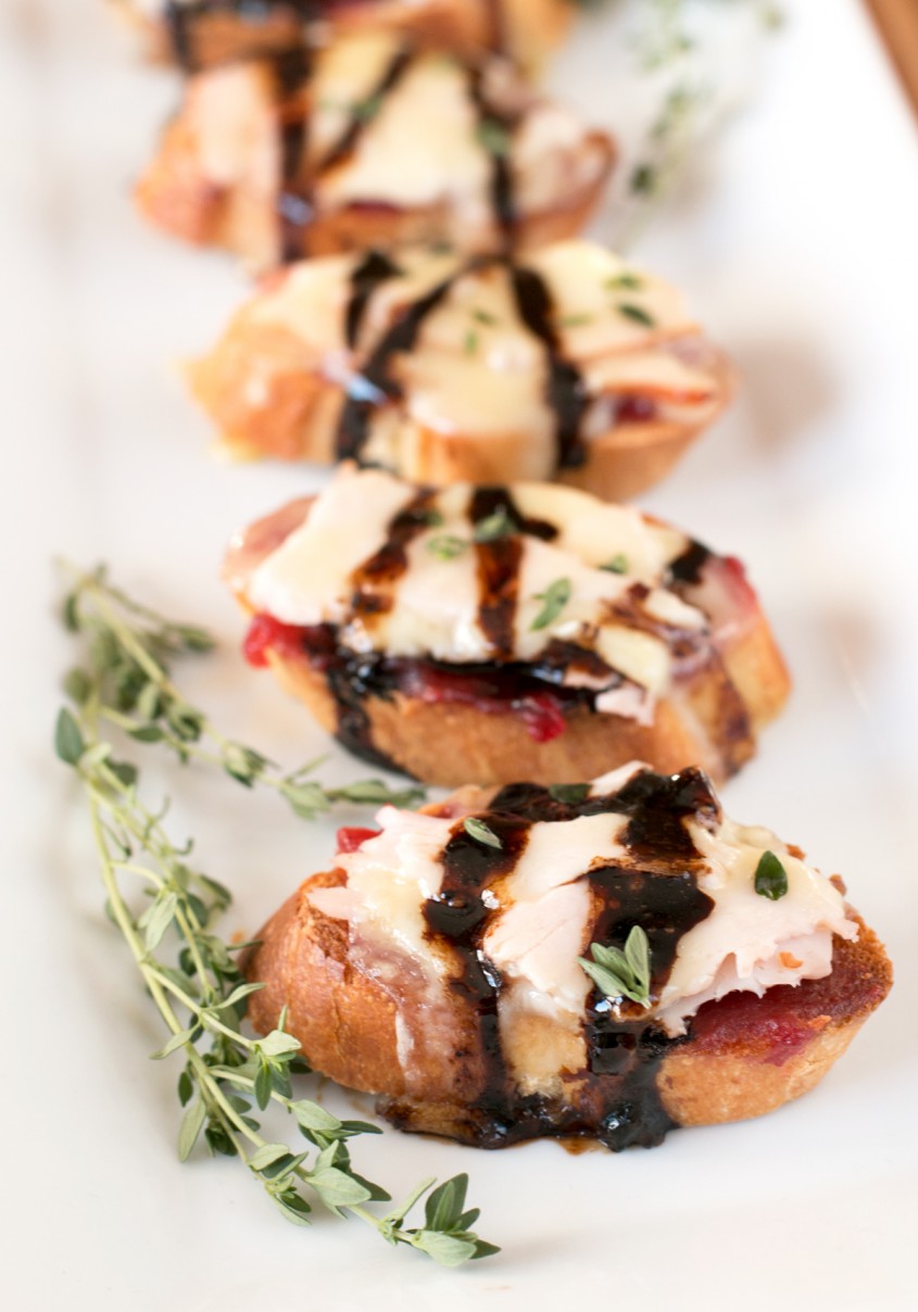 Turkey Brie Crostini. A combination of turkey and cranberry sauce to get you in the mood for Thanksgiving dinner, plus a hefty dose of melted, gooey brie.