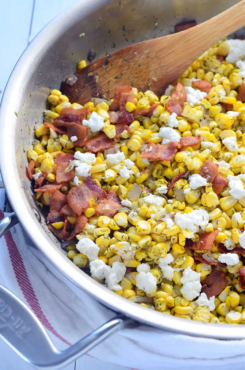This 5 ingredient warm corn salad is loaded with sweet corn, dill, bacon, shallots and goat cheese. It's the perfect way to showcase summer corn. 