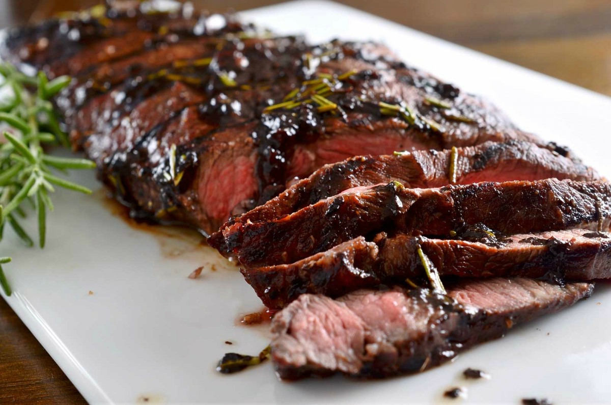 Grilled Rosemary and Balsamic Steak is the perfect, easy summer meal! Grilled flat iron steak topped with a balsamic, red wine, rosemary and garlic reduction. 