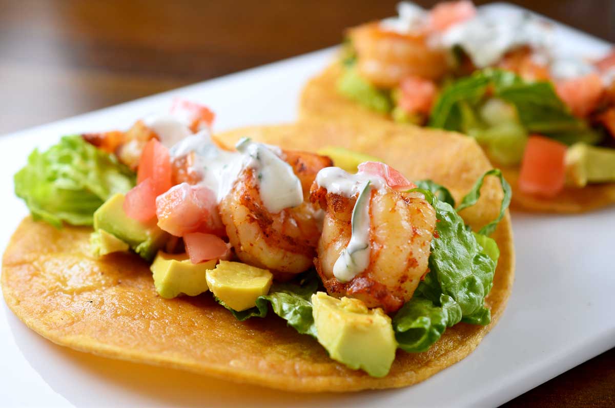 Shrimp tacos with Cilantro Lime Sour Cream are THE perfect taco for all your summer gatherings.