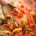Spoonful of baked ravioli.