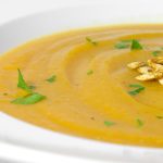 close up of butternut squash in white bowl.