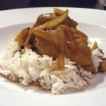 Chicken adobo in white bowl.