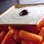 Greek skordalia in a square bowl with carrots.