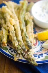 Asparagus Fries are every bit as addicting as they sound. Coated in a light batter, fried to perfection and dipped in a creamy caper aioli.