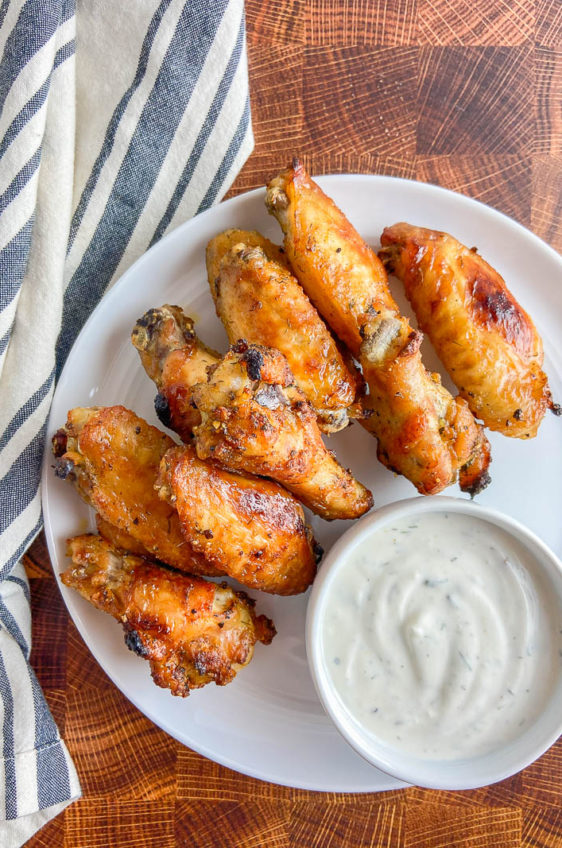 Overhead shot of beer brined chicken wings on white plate.