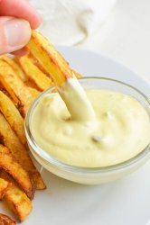 Dipping a french fry in fry sauce.