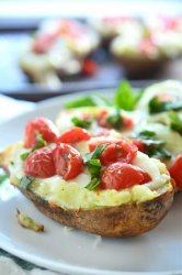 A comfort food classic gets a summer time twist with these Caprese Twice Baked Potatoes. They are loaded with pesto, mozzarella, tomatoes and fresh basil.