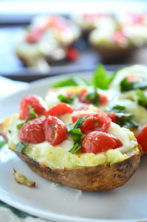 A comfort food classic gets a summer time twist with these Caprese Twice Baked Potatoes. They are loaded with pesto, mozzarella, tomatoes and fresh basil.