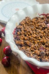 This Cherry Chocolate Chip Cookie Crisp is the perfect way to use summer cherries. Fresh sweet cherries topped with a chocolate chip cookie crumble and baked until bubbly.