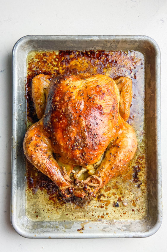 Overhead photo of crispy oven roasted chicken in a pan.