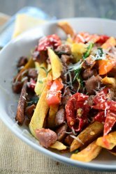 Dirty Fries are loaded with andouille sausage, mama lil's peppers, fried herbs and parmesan. Go ahead treat yourself.