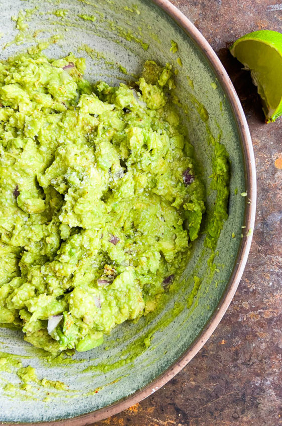 Forget the pre-made stuff, with this classic easy guacamole recipe you'll have fresh guacamole in no time.  Just a few simple ingredients is all you need to make this party perfect kitchen staple. 